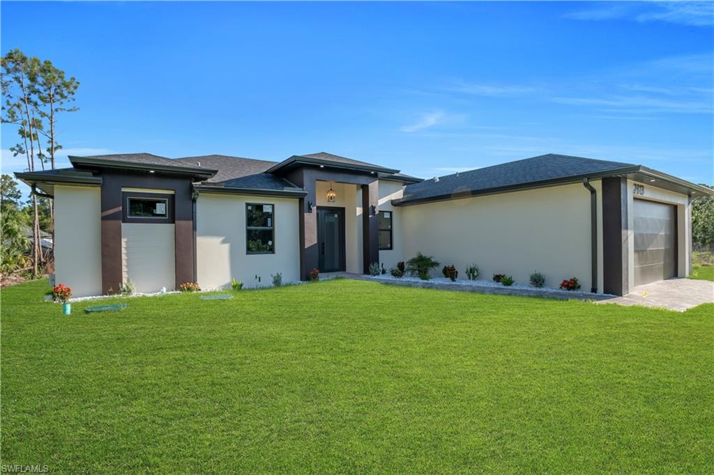 Contemporary exterior with a dark shingle roof, stucco siding, and a modern garage door