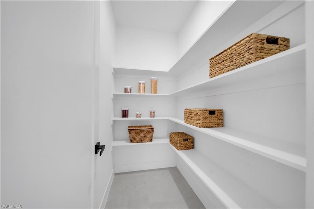 Built-in shelving with wraparound design, white finish, and black door hardware