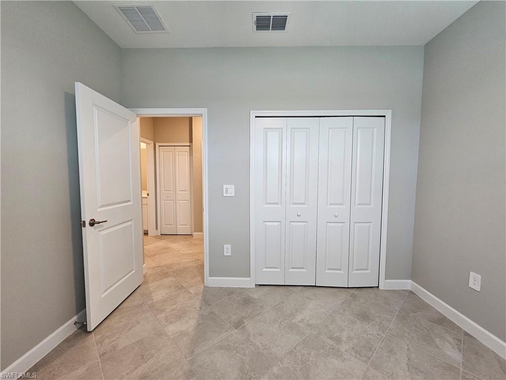 Neutral-toned walls complement the large format tile flooring
