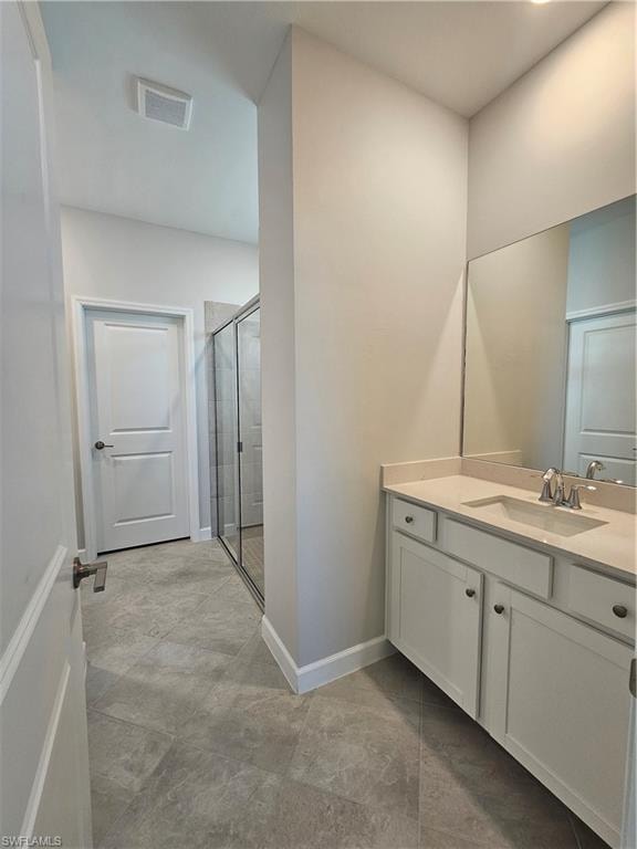 Contemporary bathroom with stone-finish tile flooring, a single vanity with an undermount sink, and a glass-enclosed shower
