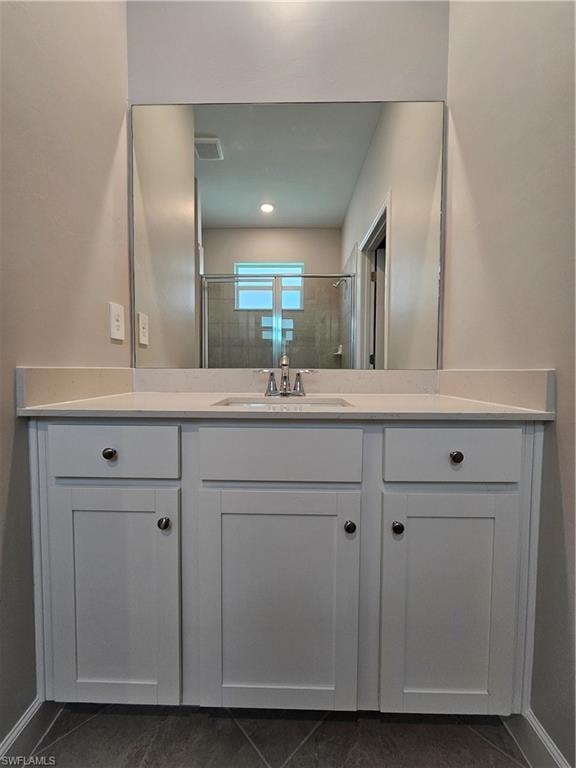White shaker-style vanity with a light-colored countertop and undermount sink