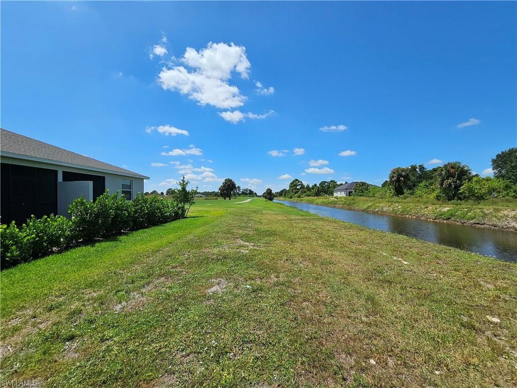 Lush green lawn with established shrubbery, offering direct canal access