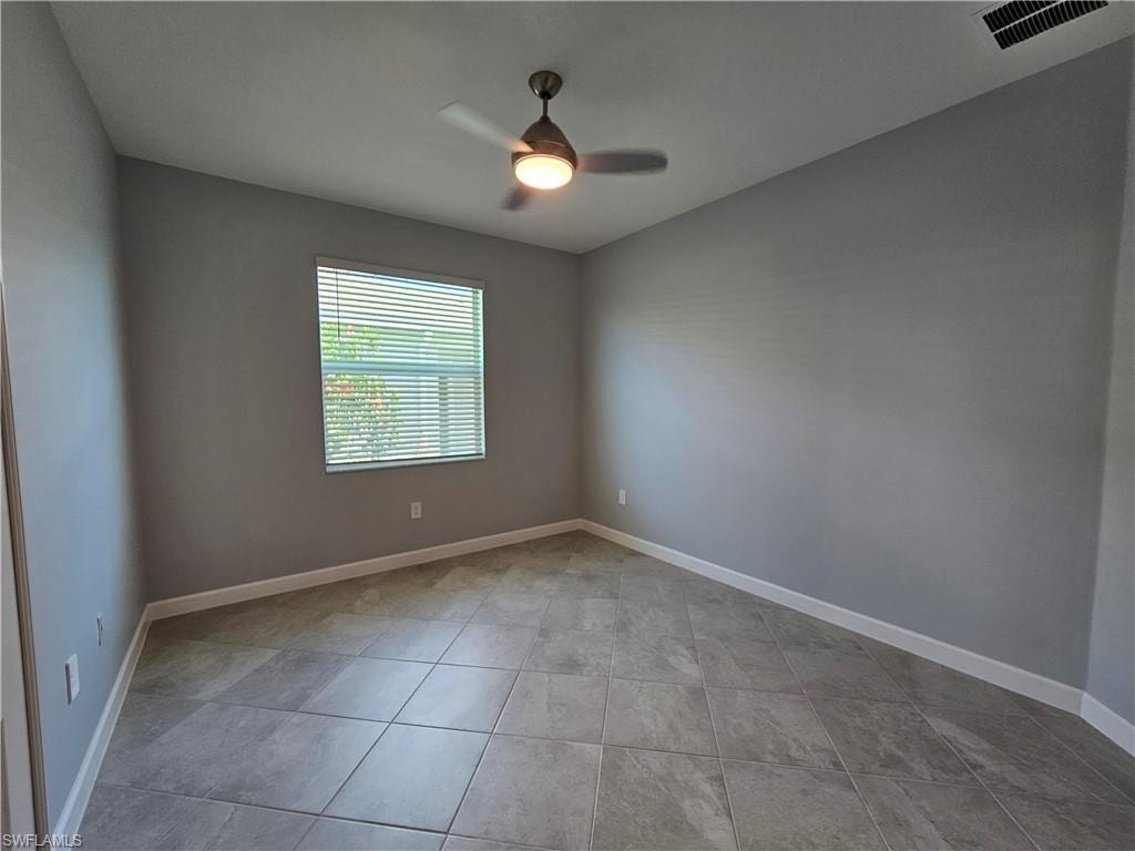 Neutral toned walls and tile flooring in a geometric pattern