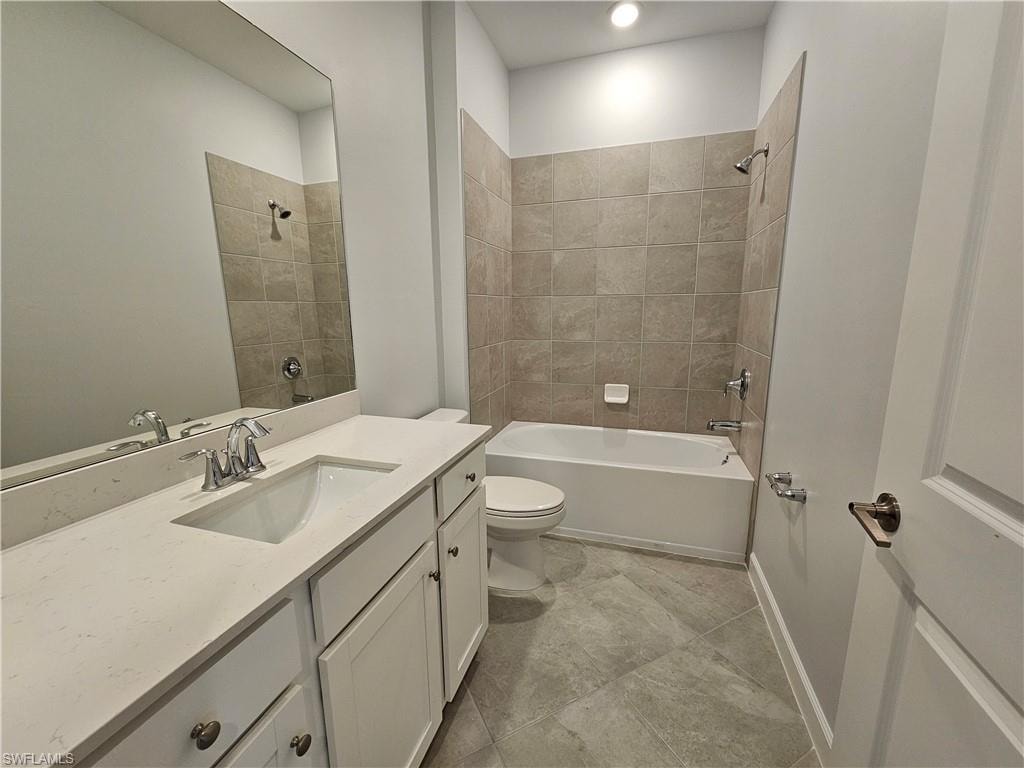 White vanity with stone-finish countertop, undermount sink, and chrome faucet