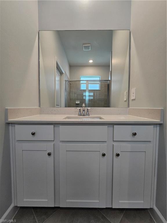 White vanity with shaker-style cabinetry, a built-in rectangular sink, and a spacious countertop