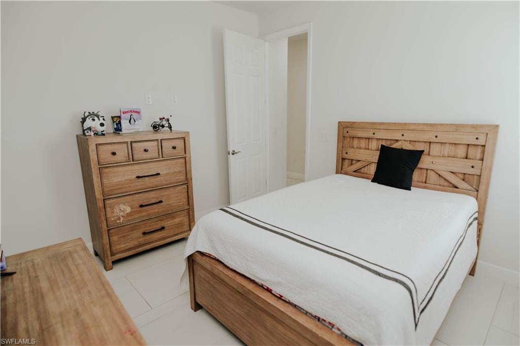 Bedroom with light tile patterned flooring