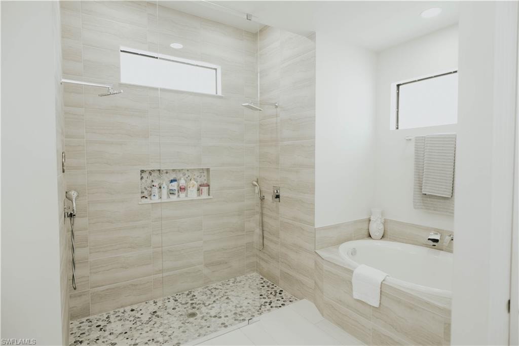 Full bathroom featuring tiled shower and a bath