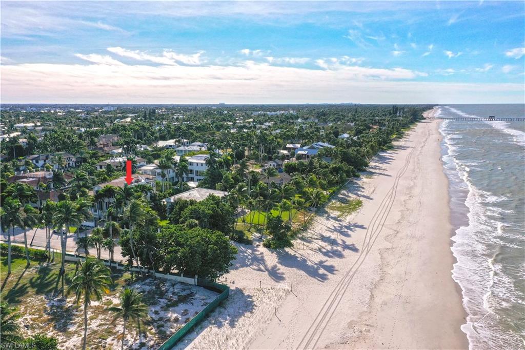 Beachfront property with extensive sandy shoreline and ocean waves