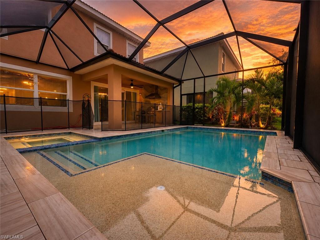 Screen-enclosed pool deck featuring a spa, integrated pool steps, and a sun shelf