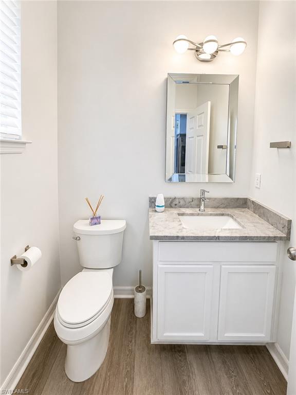 White vanity with a light-toned countertop and an undermount sink