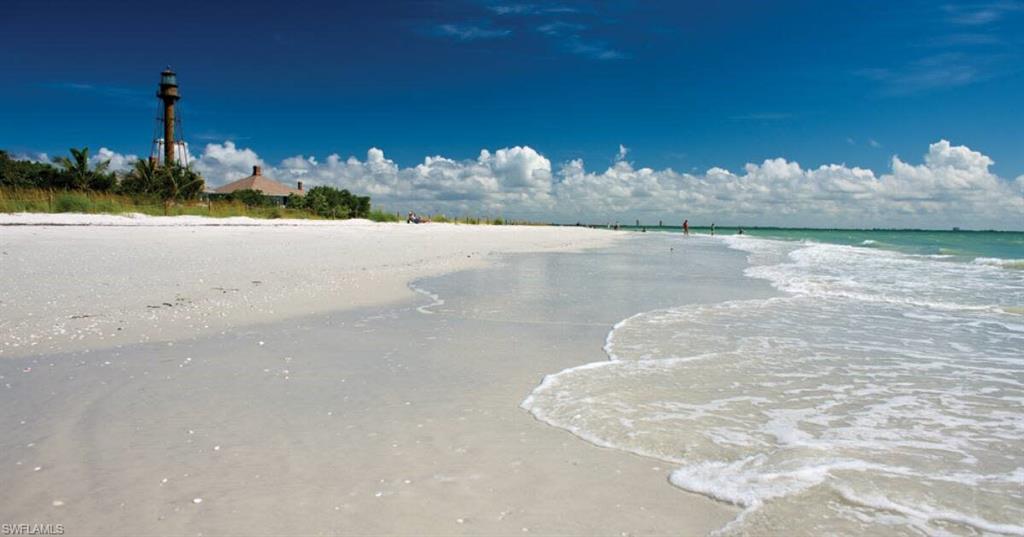 Expansive white sand shoreline with gentle ocean waves