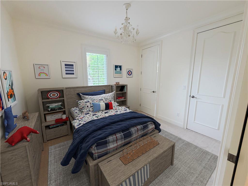 Crown molding, recessed lighting, white paneled doors, and a decorative chandelier