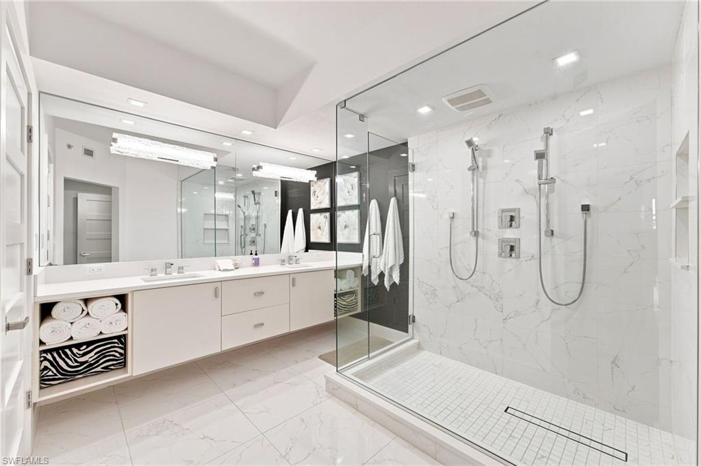 Dual vanity with undermount sinks, full-width mirror, and integrated storage