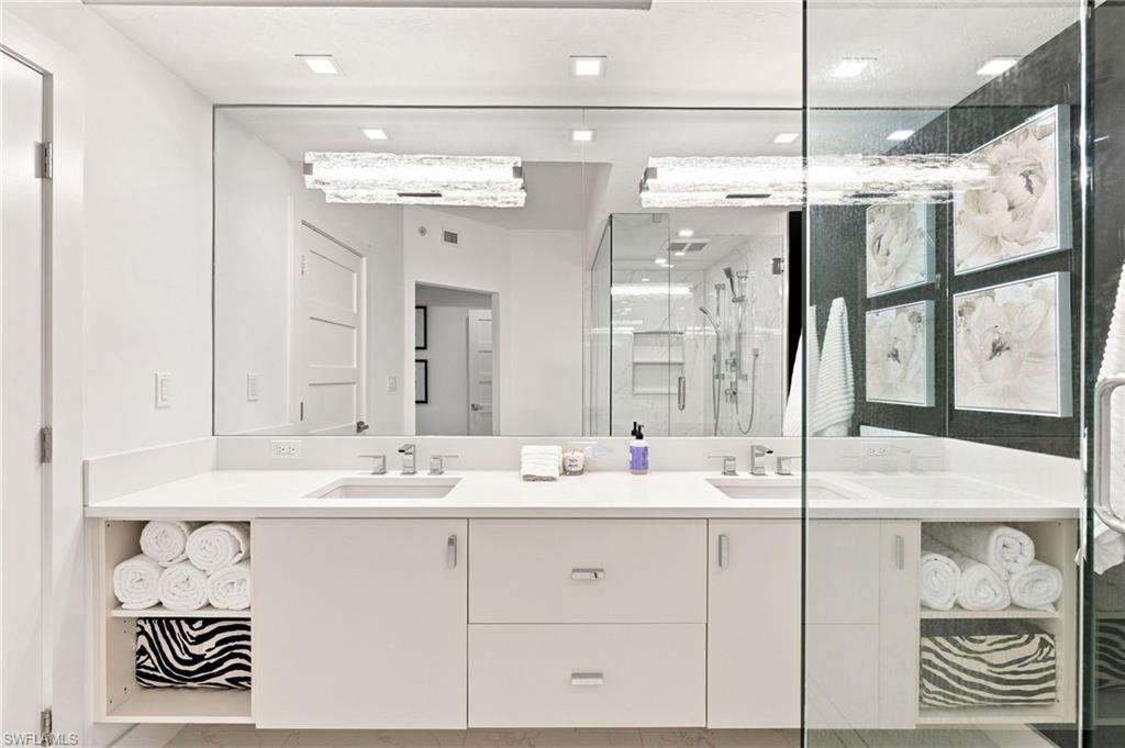 Spa-inspired primary bathroom featuring an expansive vanity with dual sinks, soft-close cabinetry, and generous storage