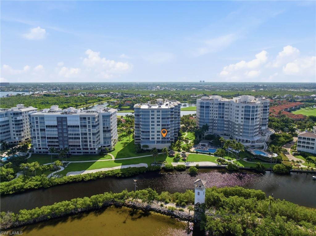 High-rise residential buildings featuring multiple balconies, manicured green spaces, and integrated swimming pools