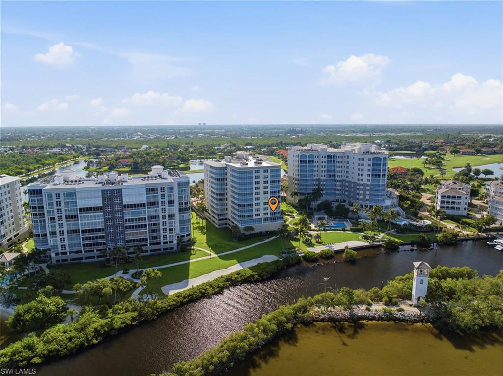 Waterfront high-rise community featuring multiple residential towers, a marina with boat slips, and an outdoor swimming pool with surrounding deck