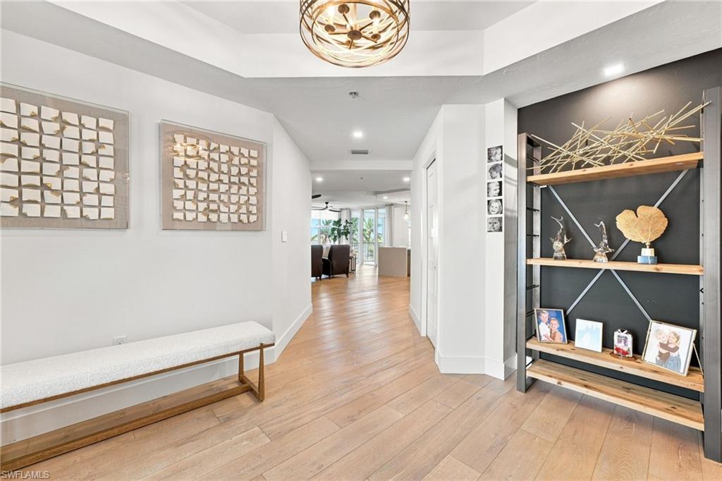 Wood-finish flooring throughout, recessed lighting, and a decorative ceiling light fixture
