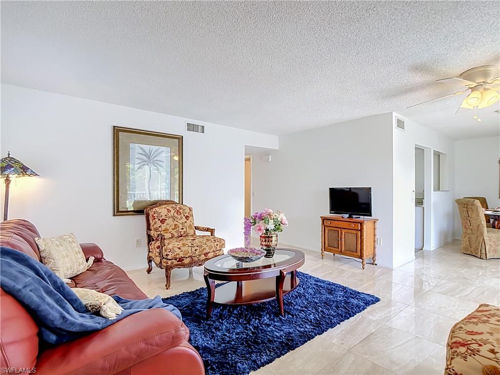 Spacious living area featuring polished tile flooring throughout