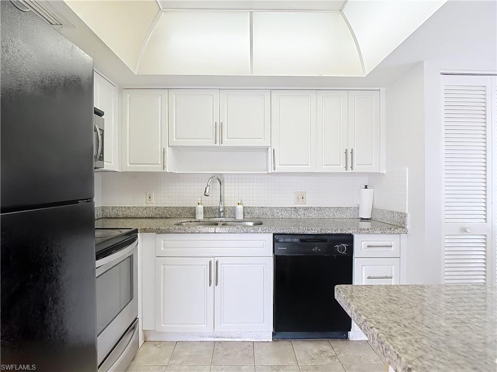 Kitchen featuring white shaker-style cabinetry, granite-finish countertops, and a subway tile backsplash