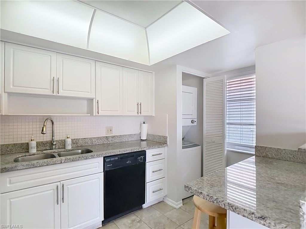 Kitchen featuring white cabinetry, a double basin sink with a gooseneck faucet, a built-in dishwasher, and granite-finish countertops