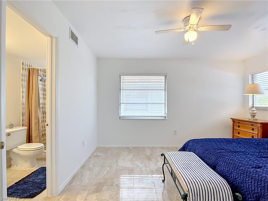 Living space with polished tile flooring, a ceiling fan, and window blinds