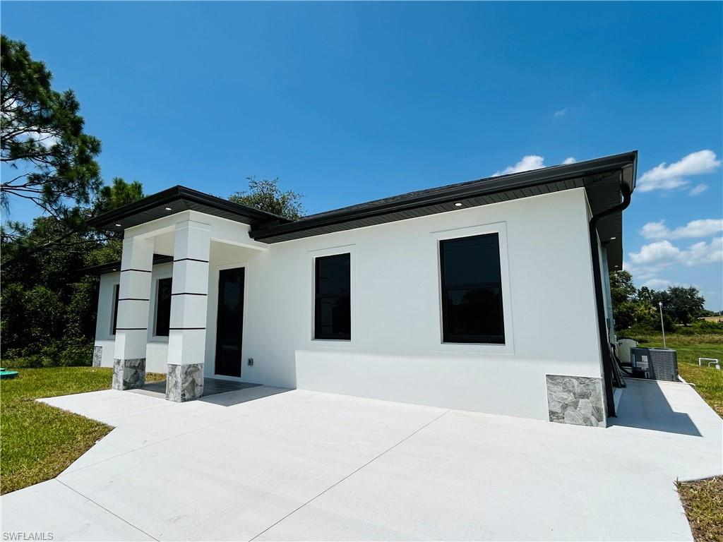 White exterior with dark trim and stone accents