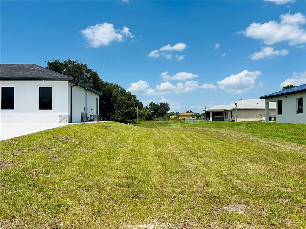 Expansive lot featuring a grassed surface and mature perimeter trees