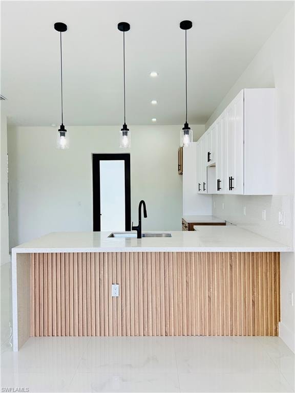 Kitchen island with ribbed wood paneling and a waterfall-edge countertop