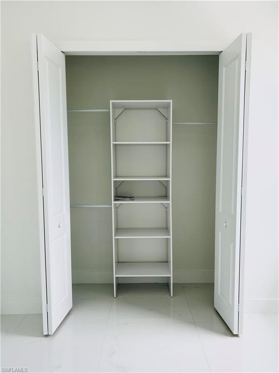 Custom closet shelving with multiple rods and a five-tier storage unit