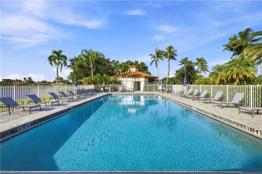 Resort-style pool with a tiled surface and perimeter fencing