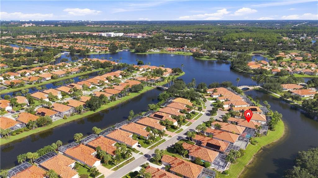 Waterfront community with extensive waterways, uniform red tile roofs, and lush landscaping