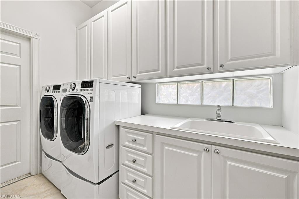 White shaker-style cabinetry, recessed lighting, drop-in utility sink, glass block window, and wood-finish flooring