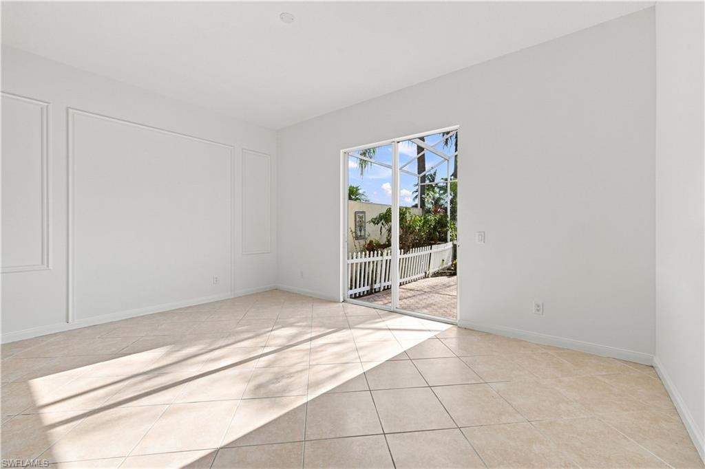 Tiled flooring, sliding glass door, white wall paneling, recessed lighting, outdoor patio