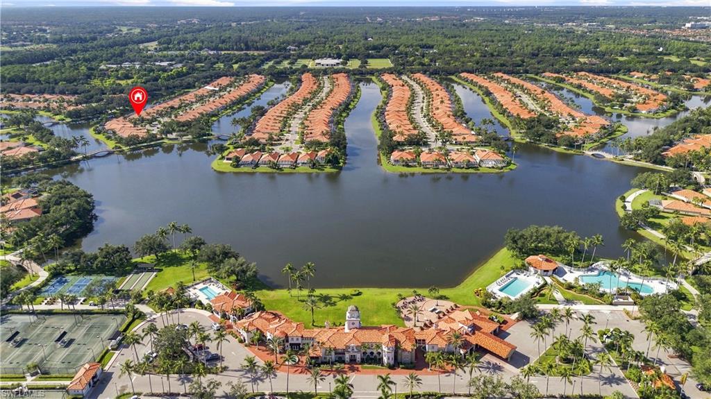 Expansive lake with surrounding properties, multiple tennis courts, and a large resort-style pool area