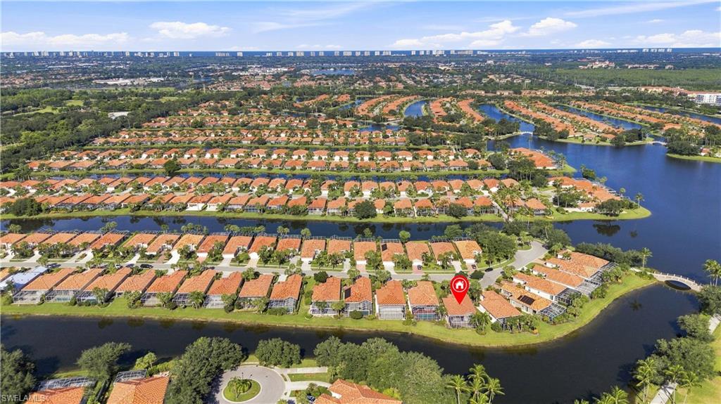 Aerial perspective showcasing a residential community with water features and mature landscaping