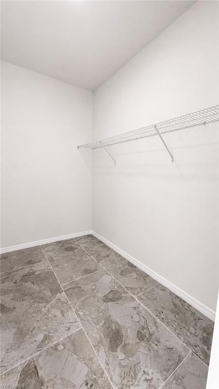 White walls and a wire shelf system complement the grey tile flooring