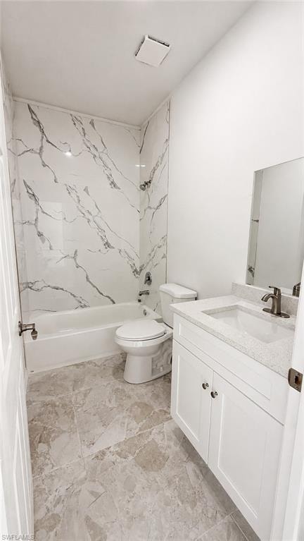 Contemporary bathroom featuring a white bathtub, toilet, vanity with integrated sink, and a mirrored wall