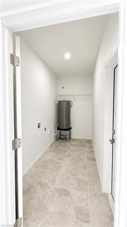 Utility room featuring light-toned tile flooring, recessed lighting, and a built-in wire shelf