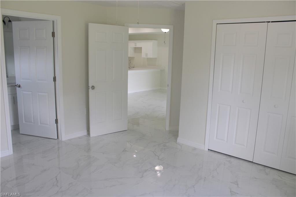 White paneled doors, bifold closet doors, and light-toned walls