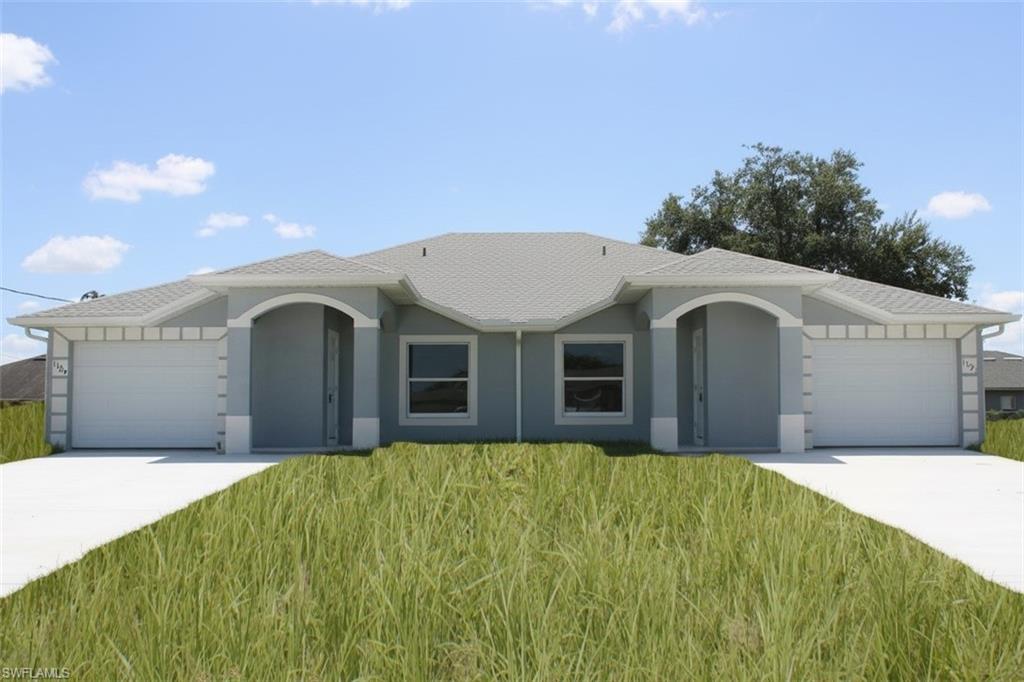 Duplex property featuring a light gray exterior, white trim, and a gray shingle roof