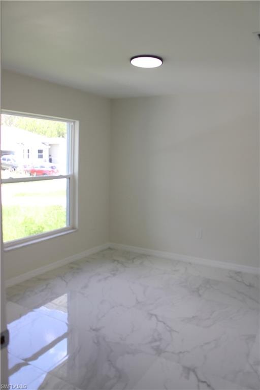 White walls, window, and ceiling-mounted light fixture, with patterned tile flooring
