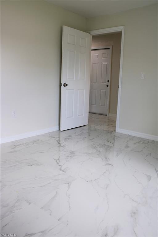 White paneled door with a contrasting dark knob, set against light-toned walls