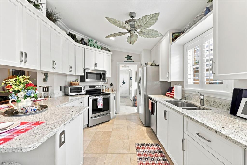 Updated custom quartz counter-tops with stainless steel appliances