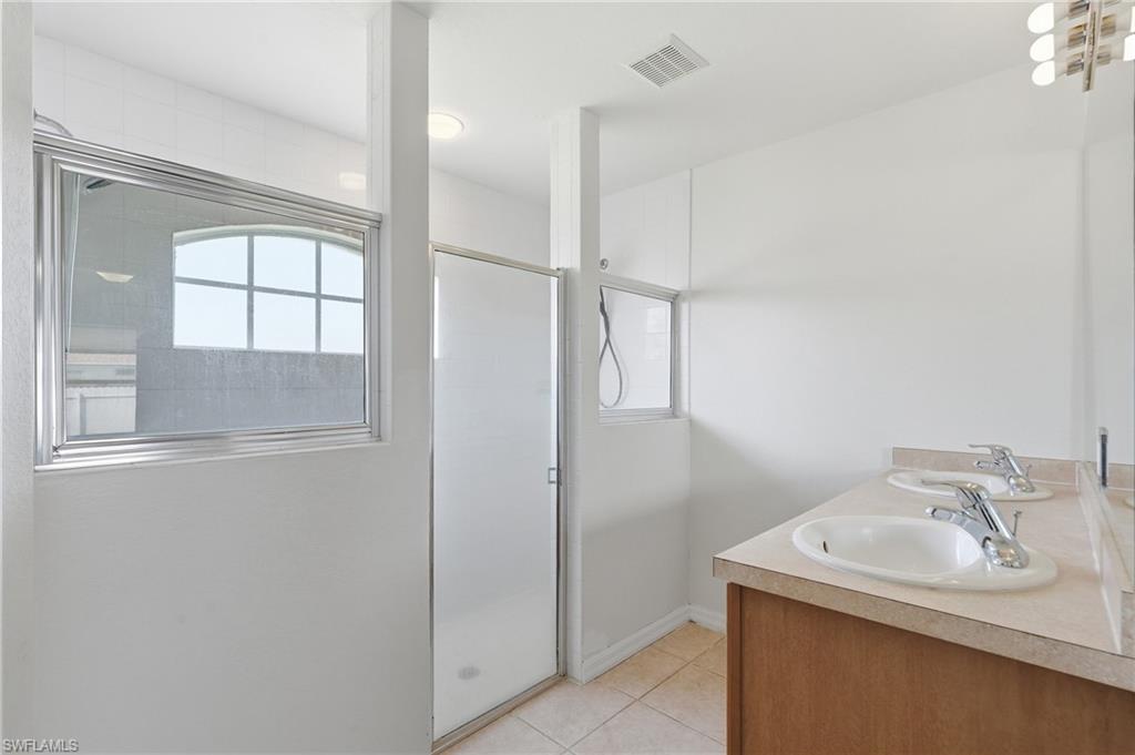 Dual vanity with integrated sinks, chrome fixtures, and a neutral countertop