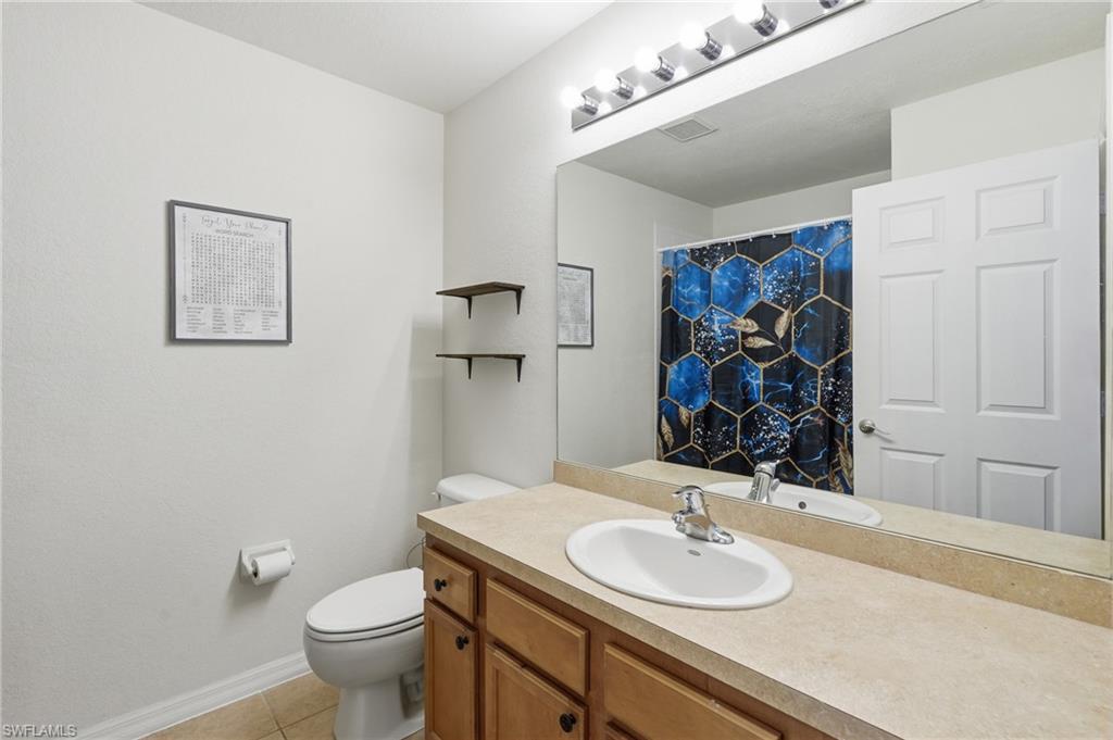 Guest Bathroom featuring a vanity with one sink, light-toned countertop, and cabinetry