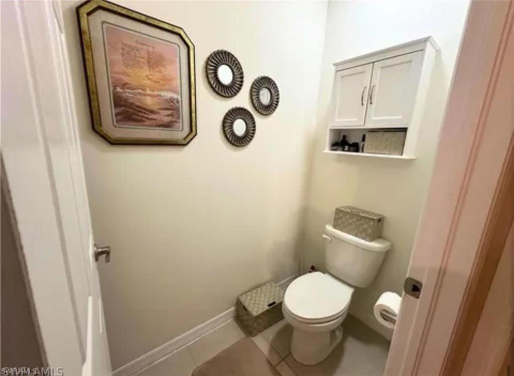Wall-mounted storage cabinet with a lower open shelf