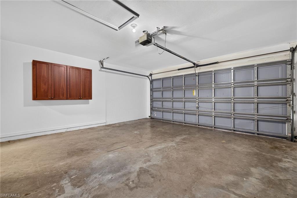 Garage with metal storm protection panels and storage cabinets