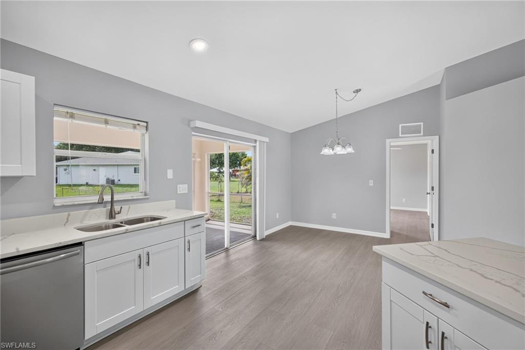 Kitchen facing dining room with lanai on left and minor bedroom entry on right