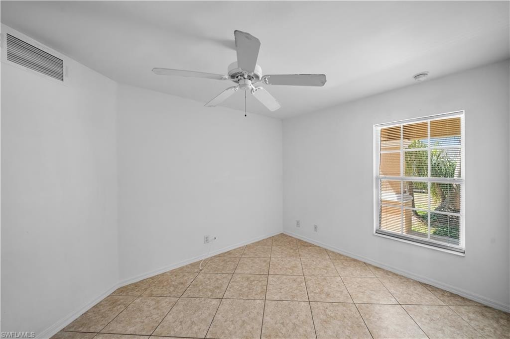 Room with tiled flooring, white walls, a ceiling fan, and a single window with horizontal blinds