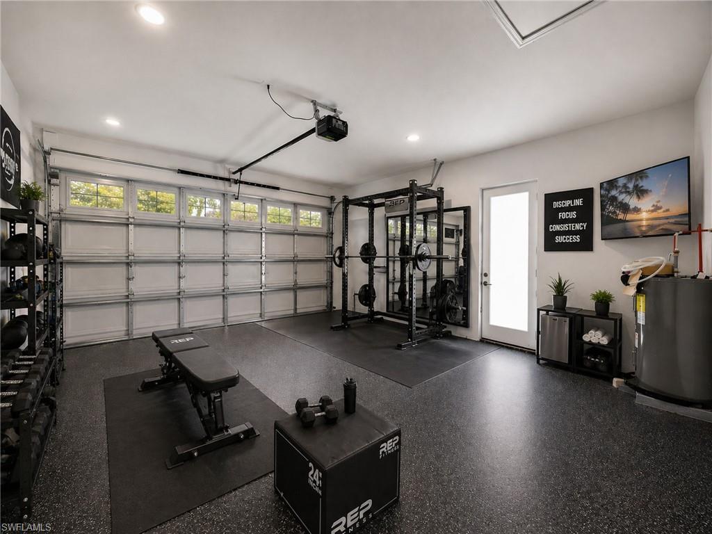 virtually staged:Garage space featuring a rubberized flooring system and recessed lighting